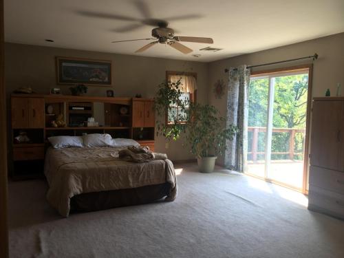 a bedroom with a bed and a ceiling fan at Mountain house in Palmerton