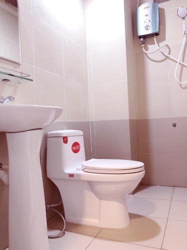a bathroom with a white toilet and a sink at Aurora Hotel in Ho Chi Minh City