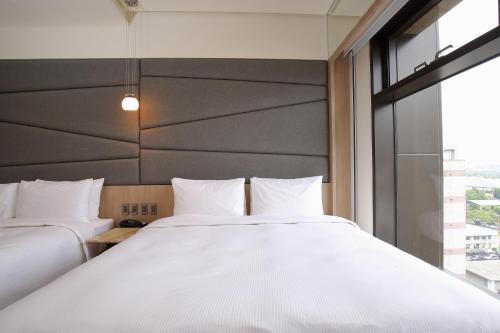 Un ou plusieurs lits dans un hébergement de l'établissement Kloud Hotel