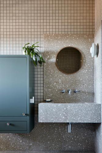a bathroom with a sink and a mirror at Polperro Farmhouse in Red Hill