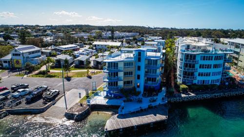 an aerial view of a large apartment building next to the water at Tripcony Quays in Caloundra