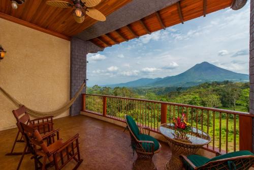 a balcony with a view of a mountain at The Springs Resort & Spa at Arenal in Fortuna