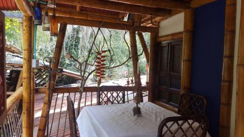a dining room with a table and a large window at Hospedaje Rural Tupinamba in Ibagué