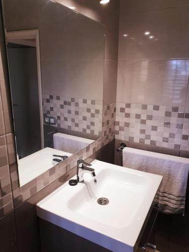 a bathroom with a white sink and a mirror at Apartamentos Ronsan in Maspalomas