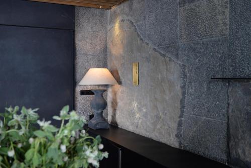 a lamp sitting on a table next to a wall at Yakamoz Erhai Hotel in Dali