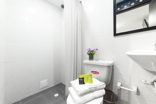 a white bathroom with a toilet and a sink at Ayenda 1045 Boutique Aeropuerto in Bogotá