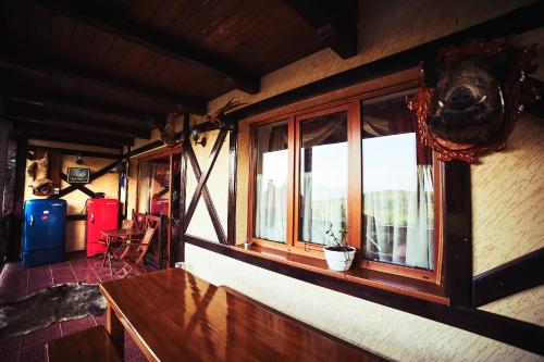a room with a window and a table with a plant at 12 Місяців-Травень, басейн з підігрівом in Slavske
