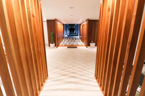 a hallway with wooden doors leading into a building at Cactus in Puerto Baquerizo Moreno
