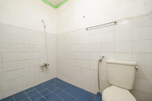 a bathroom with a toilet and a shower at RedDoorz @ Tuktuk Danau Toba in Tuk Tuk