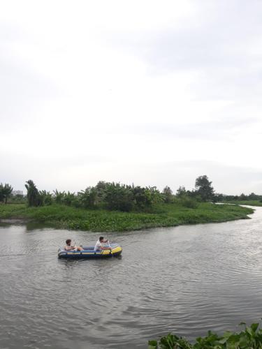 two people in a boat on a river at Saigon Garden Homestay in Ho Chi Minh City