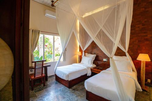 Ένα ή περισσότερα κρεβάτια σε δωμάτιο στο The Trang Villas