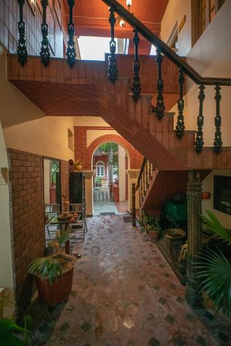 a large hallway with a staircase in a house at Ranjit's Svaasa Amritsar in Amritsar