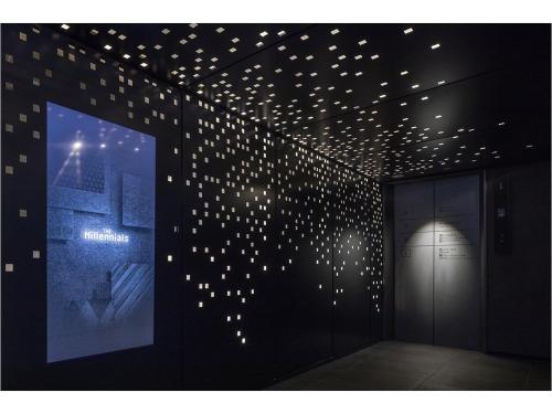 a room with a bunch of lights on the wall at The Millennials Fukuoka in Fukuoka