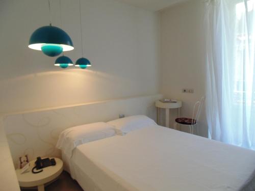 a bedroom with two beds and a green light at Shalai - Exclusive SPA and small gourmet hotel in Linguaglossa