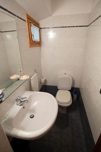 a bathroom with a white sink and a toilet at Il Rifugio in Pracchia