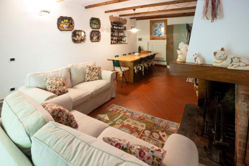 a living room with a couch and a fireplace at Il Rifugio in Pracchia