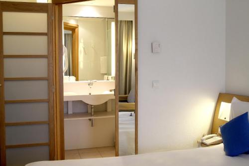 a bathroom with a sink and a mirror at Novotel Constantine in Constantine
