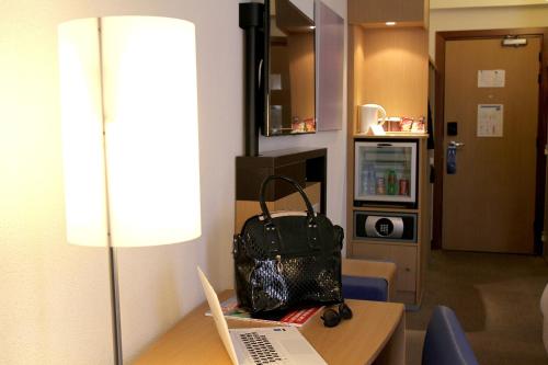 a bag sitting on a table with a laptop computer at Novotel Constantine in Constantine