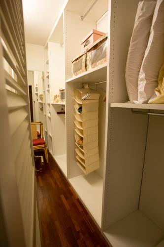 a walk in closet with white walls and wooden floors at Il Rifugio in Pracchia