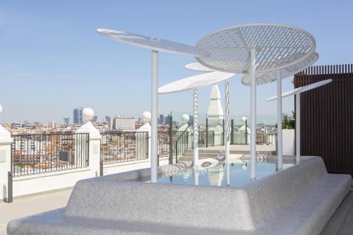 a table with two umbrellas on top of a building at Riu Plaza España in Madrid