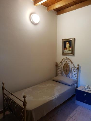 a bedroom with a bed with a light on the wall at La Baita in Boario Terme