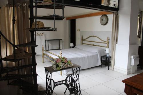 a bedroom with a bed and a spiral staircase at Un loft solo per i tuoi occhi in Bergamo