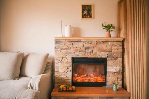 a fireplace in a living room with a fire place at Eden Court in Lijiang