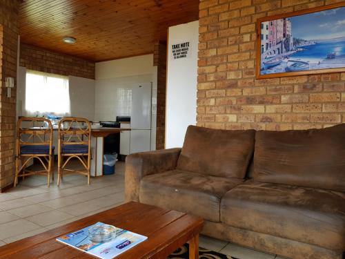a living room with a couch and a table at Port Edward Holiday Resort in Port Edward