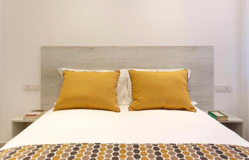 Ένα ή περισσότερα κρεβάτια σε δωμάτιο στο Delle Rose Suites