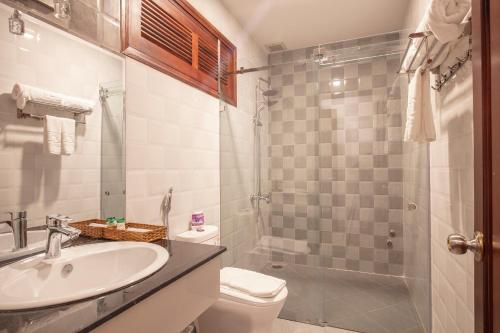 a bathroom with a sink and a toilet and a shower at Interstella Hotel in Da Lat