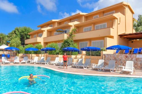 a couple playing in the pool at a hotel at Residence Le Onde in Badesi