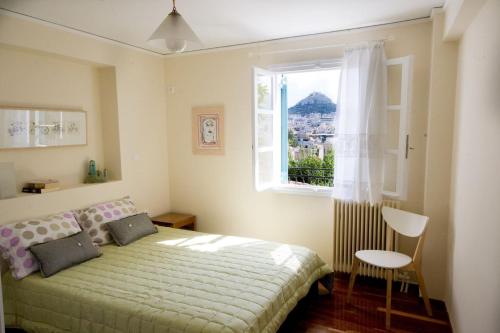a bedroom with a bed and a window at In the shadow of Acropolis in Athens