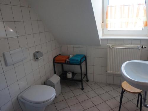 a small bathroom with a toilet and a sink at Gasthaus Zur Krone in Windelsbach
