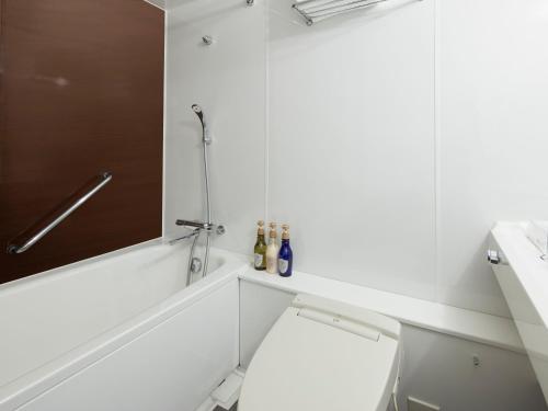 a bathroom with a toilet, sink, and bathtub at HOTEL MYSTAYS Kiyosumi shirakawa in Tokyo