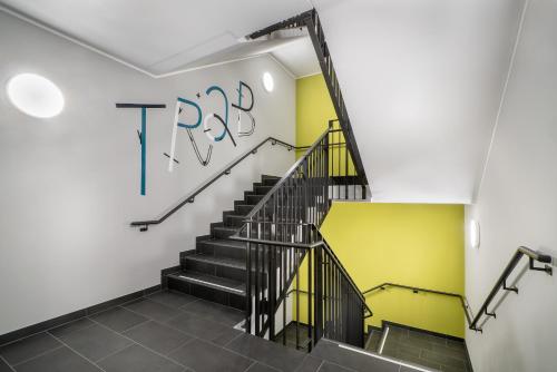 a staircase in a house with a sign on the wall at Holiday Inn - the niu, Fury Aschheim Messe by IHG in Aschheim