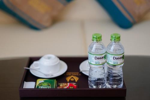 two bottles of water sitting on a table at Vincent Halong Hotel in Ha Long