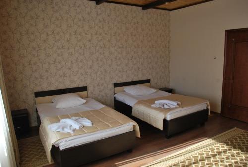 a room with two beds with towels on them at versal in Ternopilʼ