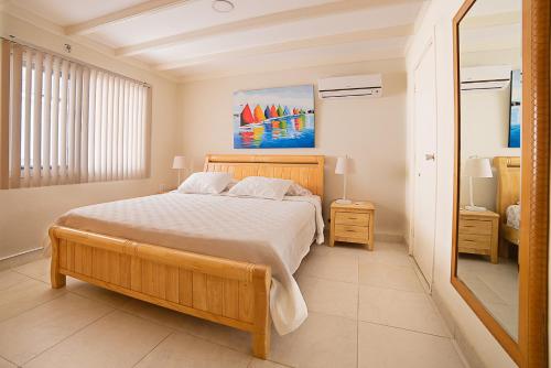 a bedroom with a bed and a painting on the wall at Hacienda Wayaca Apartments in Wayaca