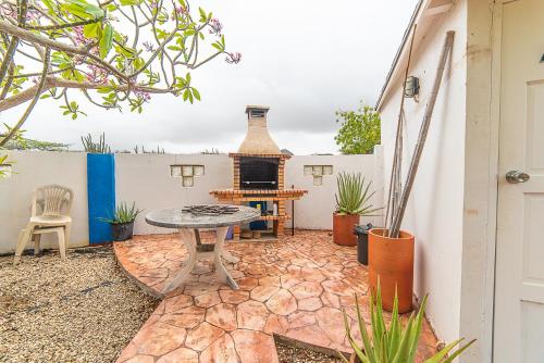 a patio with a table and a fireplace at Hacienda Wayaca Apartments in Wayaca
