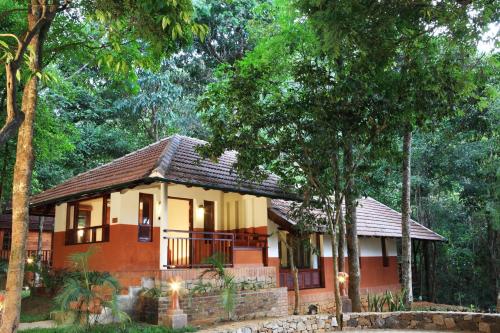 a small house in the middle of a forest at Vythiri Resort in Vythiri