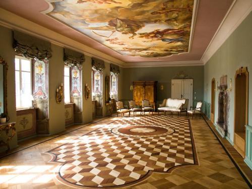 a large room with a painting on the ceiling at Pałac Pakoszów Schlosshotel Wernersdorf in Jelenia Góra