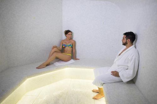 a man and a woman sitting in a bath tub at Eden Hotel & Spa in Cannes