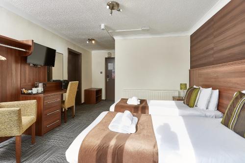 Ein Bett oder Betten in einem Zimmer der Unterkunft St. Margaret's Hotel