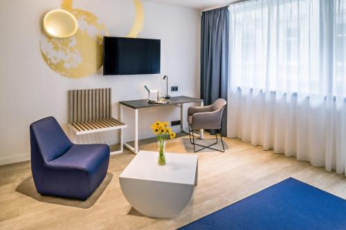 a room with a desk and two chairs and a table at Cortile Hotel - Adults Only in Budapest