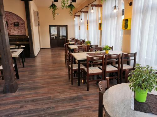 a row of tables and chairs in a restaurant at Комплекс Антик in Troyan