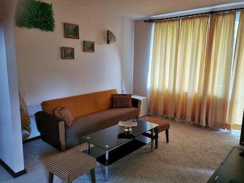 a living room with a couch and a table at Комплекс Антик in Troyan