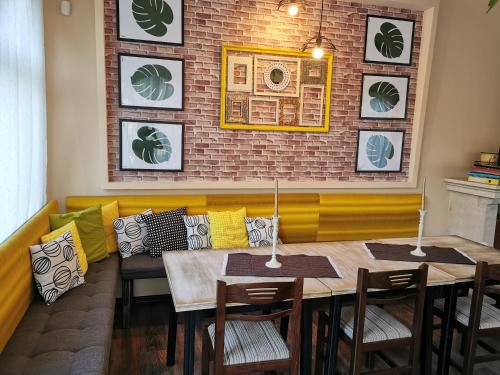 a dining room with a table and chairs and a brick wall at Комплекс Антик in Troyan