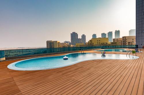 a swimming pool on the roof of a building at Millennium Place Barsha Heights Hotel Apartments in Dubai