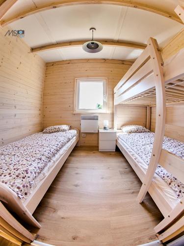 a bedroom with two bunk beds and a window at Ośrodek Bajka in Zator