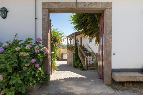 an open door to a house with flowers at Quinta Da Estrada Winery Douro Valley in Peso da Régua